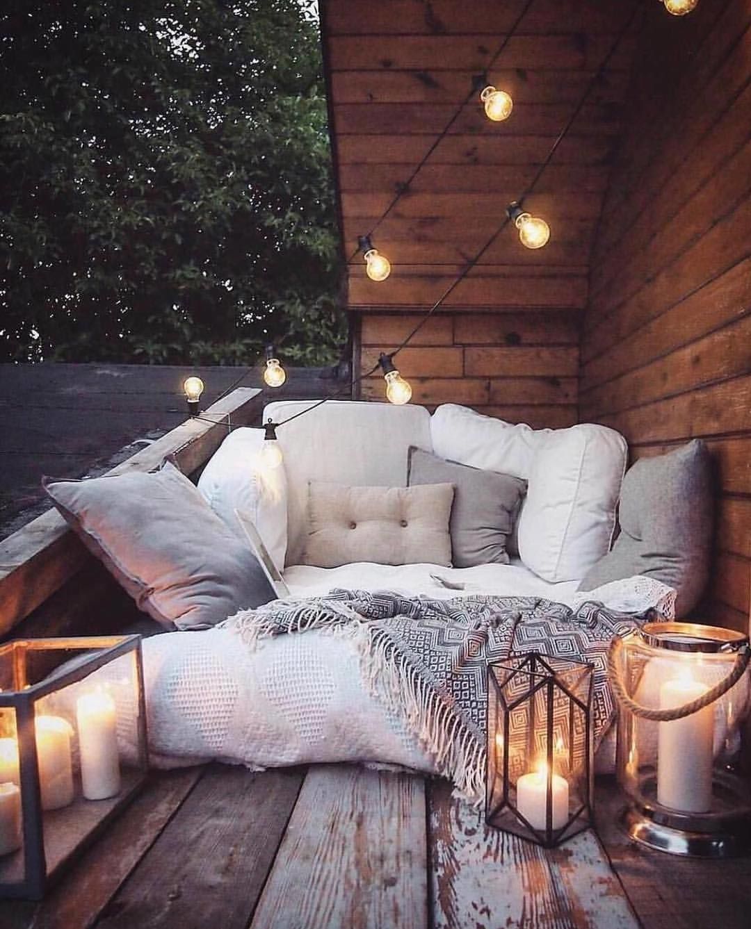 Cozy evening living space with candles and soft cushions in Netherlands home